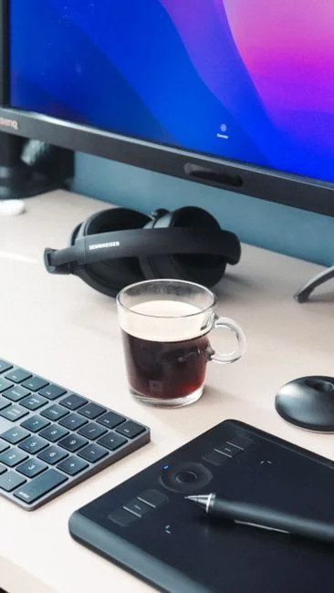 A modern computer screen displaying web design work, showcasing creative visuals in a workspace.